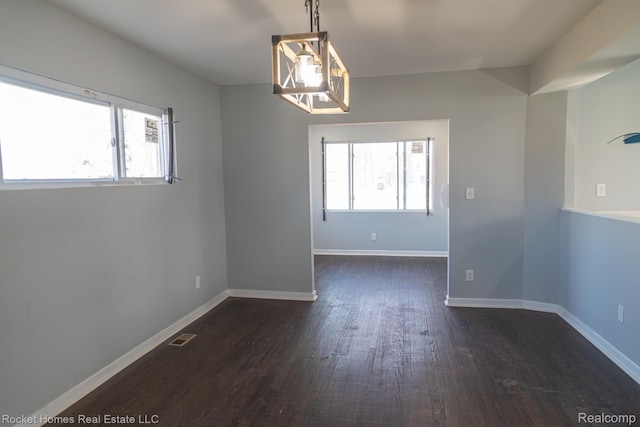3926 Three Mile Dr, Detroit, MI 48224 - spare room with dark wood-style floors and baseboards