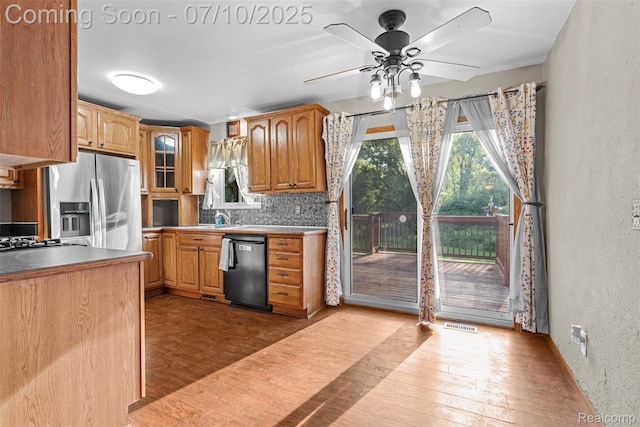 1560 Mercedes St, West Bloomfield, MI 48324 - kitchen with stainless steel fridge, dishwasher, a textured wall, wood finished floors, and decorative backsplash