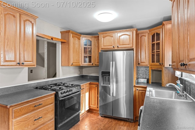 1560 Mercedes St, West Bloomfield, MI 48324 - kitchen featuring stainless steel fridge with ice dispenser, black gas range, glass insert cabinets, and dark countertops