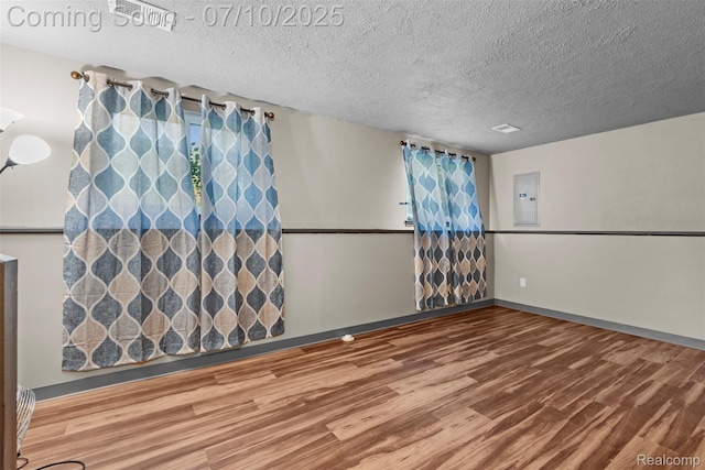 1560 Mercedes St, West Bloomfield, MI 48324 - empty room featuring wood finished floors, a textured ceiling, and electric panel
