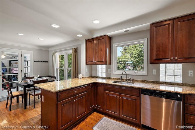 4151 Seminole Dr, Royal Oak, MI 48073 - kitchen with stainless steel dishwasher, a peninsula, light wood-style flooring, recessed lighting, and light stone counters