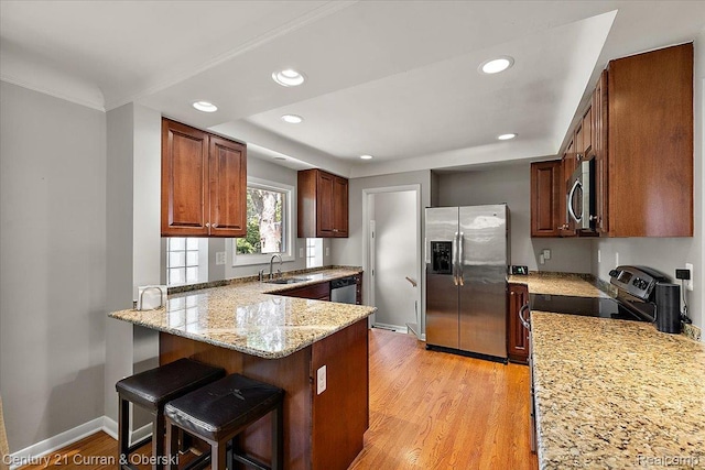 4151 Seminole Dr, Royal Oak, MI 48073 - kitchen with appliances with stainless steel finishes, light stone countertops, a peninsula, recessed lighting, and light wood-style floors