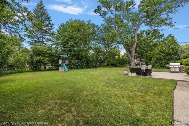 4151 Seminole Dr, Royal Oak, MI 48073 - view of green lawn featuring a patio, a playground, and view of scattered trees