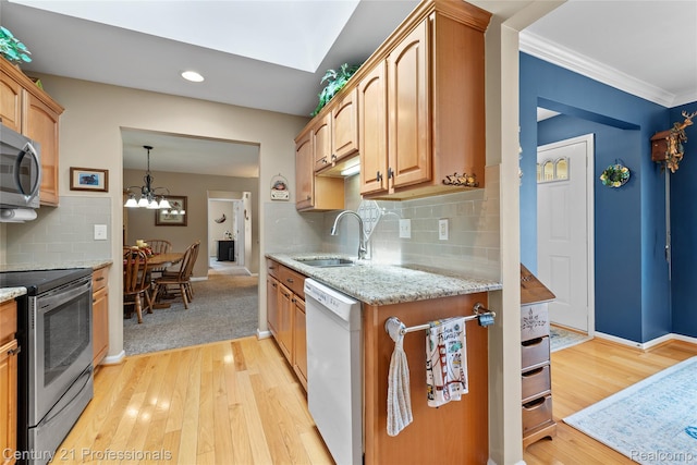 50323 Highpoint Ct, Macomb, MI 48044 - kitchen featuring appliances with stainless steel finishes, light wood finished floors, light stone counters, backsplash, and a chandelier