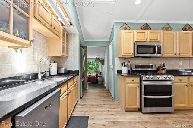 4217 Link Ave, Brighton, MI 48114 - kitchen with appliances with stainless steel finishes, crown molding, backsplash, light wood-type flooring, and glass insert cabinets