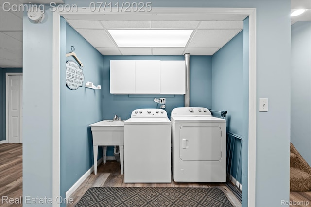 4217 Link Ave, Brighton, MI 48114 - laundry area featuring separate washer and dryer, cabinet space, and wood finished floors