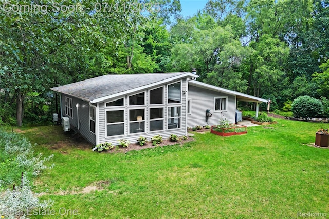 4217 Link Ave, Brighton, MI 48114 - back of property with a yard and roof with shingles