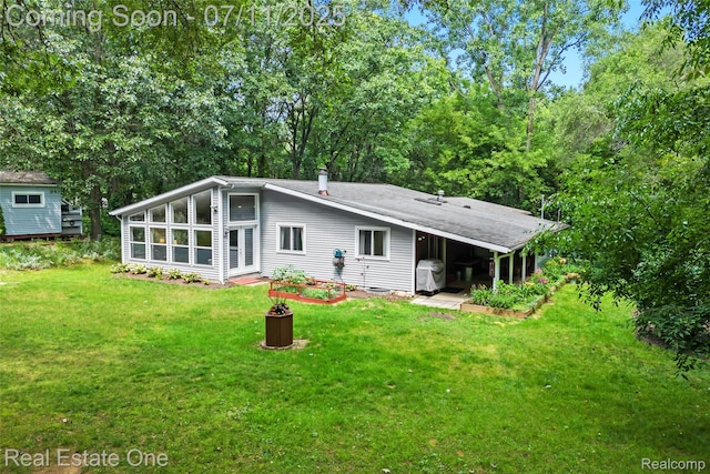 4217 Link Ave, Brighton, MI 48114 - back of house featuring a lawn