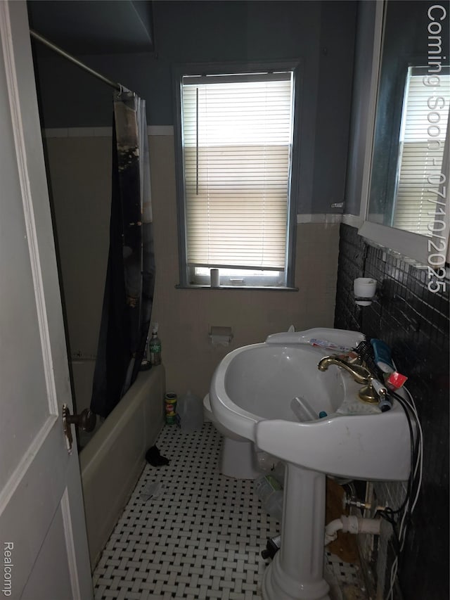 28 S Marshall St, Pontiac, MI 48342 - bathroom with shower / bathtub combination with curtain and a wainscoted wall