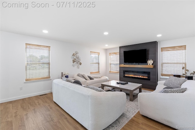 6649 Maplelawn Dr, Ypsilanti, MI 48197 - living area with a fireplace, wood finished floors, and recessed lighting