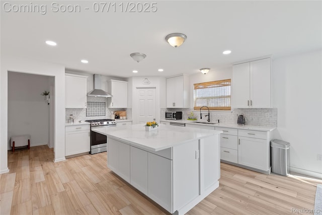 6649 Maplelawn Dr, Ypsilanti, MI 48197 - kitchen featuring stainless steel appliances, wall chimney range hood, white cabinetry, tasteful backsplash, and recessed lighting