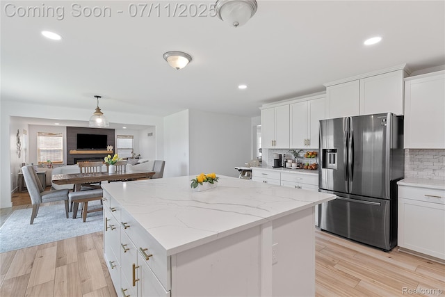 6649 Maplelawn Dr, Ypsilanti, MI 48197 - kitchen with stainless steel fridge with ice dispenser, a center island, decorative backsplash, white cabinets, and recessed lighting