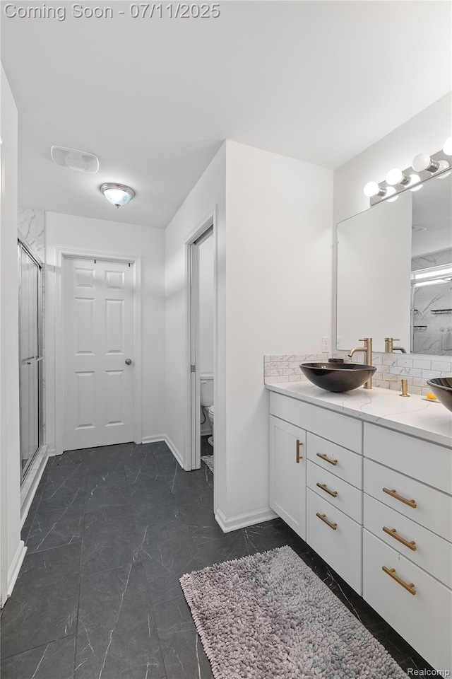 6649 Maplelawn Dr, Ypsilanti, MI 48197 - bathroom featuring vanity, a stall shower, tasteful backsplash, and marble finish flooring