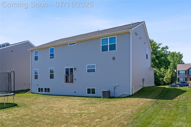6649 Maplelawn Dr, Ypsilanti, MI 48197 - back of property with a trampoline and a yard