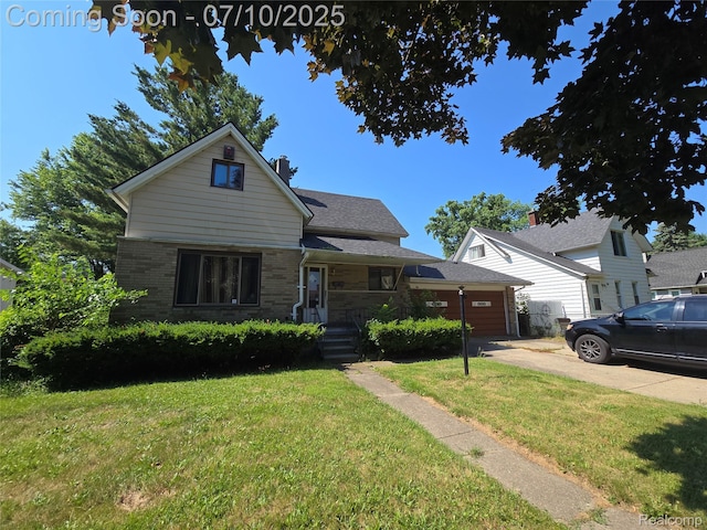 46 Michigan St, Mount Clemens, MI 48043 - view of front of property featuring a front lawn, brick siding, a chimney, and driveway