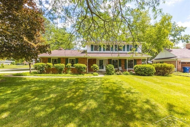 595 Stoneham Rd, Saginaw, MI 48638 - traditional-style home with a front yard and brick siding