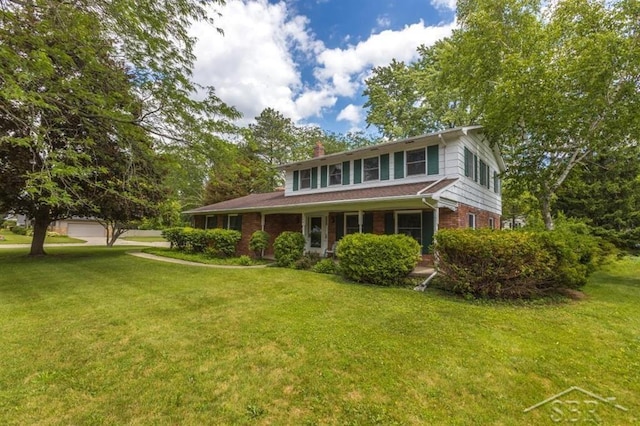 595 Stoneham Rd, Saginaw, MI 48638 - traditional home featuring a front yard, brick siding, and a chimney
