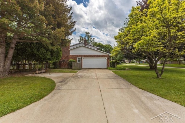 595 Stoneham Rd, Saginaw, MI 48638 - view of front of house with driveway, brick siding, and a garage