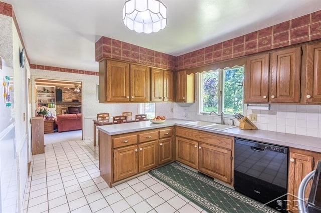 595 Stoneham Rd, Saginaw, MI 48638 - kitchen with dishwasher, light countertops, brown cabinets, a peninsula, and wallpapered walls