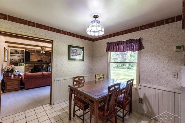 595 Stoneham Rd, Saginaw, MI 48638 - dining space featuring light tile patterned flooring, a wainscoted wall, and light carpet