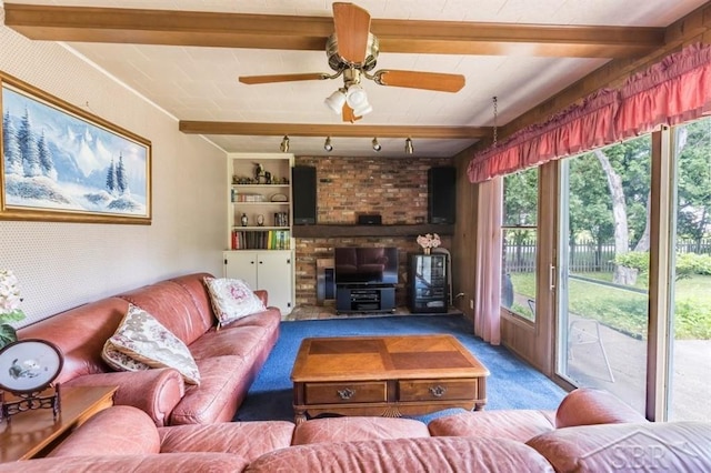 595 Stoneham Rd, Saginaw, MI 48638 - carpeted living room featuring a wood stove, a ceiling fan, built in shelves, and rail lighting