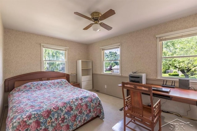 595 Stoneham Rd, Saginaw, MI 48638 - bedroom with multiple windows, an office area, carpet, and a ceiling fan
