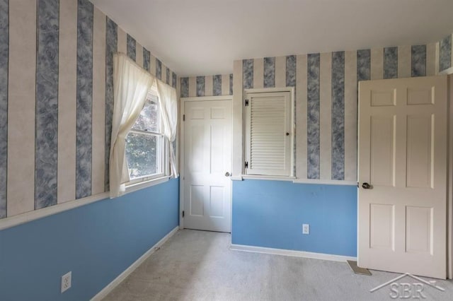 595 Stoneham Rd, Saginaw, MI 48638 - unfurnished bedroom with baseboards and carpet