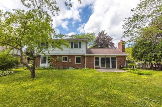 595 Stoneham Rd, Saginaw, MI 48638 - back of house with a chimney, a patio area, and brick siding