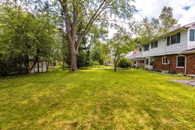 595 Stoneham Rd, Saginaw, MI 48638 - view of green lawn featuring a shed