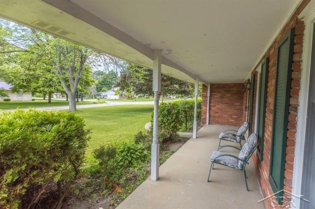 595 Stoneham Rd, Saginaw, MI 48638 - covered porch featuring a yard