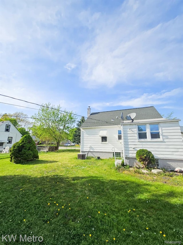 4010 Stolzenfeld Ave, Warren, MI 48091 - back of house featuring a yard and a chimney