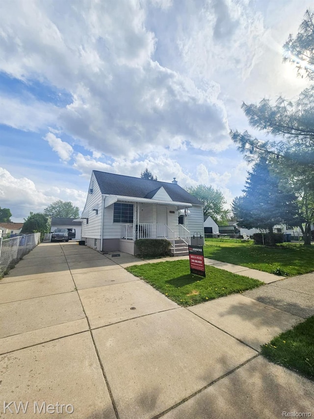 4010 Stolzenfeld Ave, Warren, MI 48091 - bungalow-style home with driveway, a porch, and a front yard