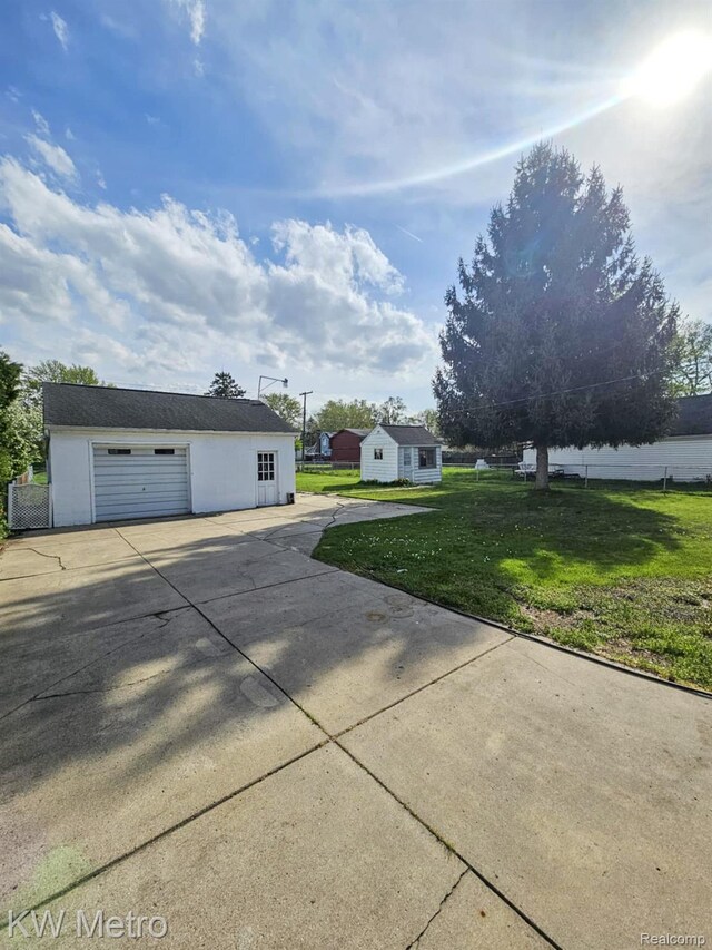 4010 Stolzenfeld Ave, Warren, MI 48091 - view of home's exterior with an outdoor structure, a yard, a garage, and driveway