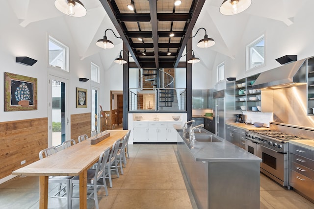 15337 Pardee Rd, Galien, MI 49113 - kitchen featuring stainless steel countertops, high end appliances, wall chimney exhaust hood, a towering ceiling, and beamed ceiling