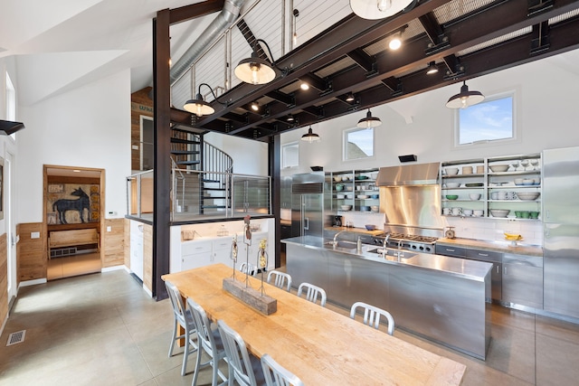 15337 Pardee Rd, Galien, MI 49113 - dining space featuring a towering ceiling, beam ceiling, and light tile patterned flooring