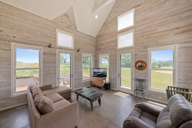 15337 Pardee Rd, Galien, MI 49113 - living room with high vaulted ceiling, finished concrete flooring, healthy amount of natural light, and wood walls