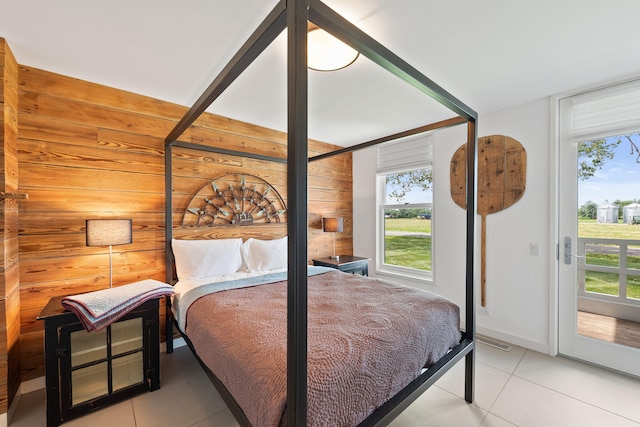 15337 Pardee Rd, Galien, MI 49113 - bedroom with wood walls, access to exterior, and light tile patterned floors