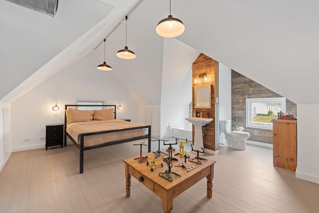 15337 Pardee Rd, Galien, MI 49113 - bedroom featuring lofted ceiling, wood walls, light wood finished floors, and ensuite bathroom