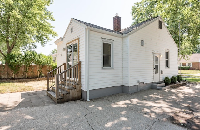 2931 Eastland Rd, Muskegon, MI 49441 - back of property featuring entry steps and a chimney