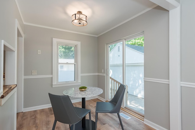 2931 Eastland Rd, Muskegon, MI 49441 - dining space featuring wood finished floors and crown molding