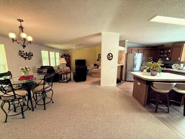 7878 Schooner Ln, Canadian Lakes, MI 49346 - dining space featuring a textured ceiling and a chandelier