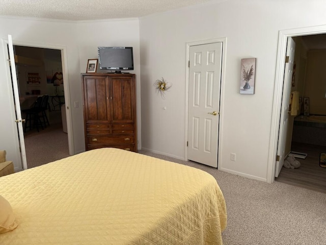 7878 Schooner Ln, Canadian Lakes, MI 49346 - bedroom with carpet floors, connected bathroom, and a textured ceiling