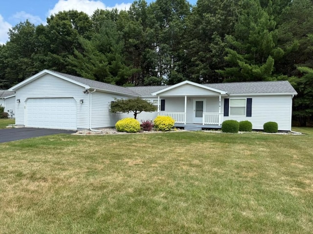 7878 Schooner Ln, Canadian Lakes, MI 49346 - single story home featuring a porch, a garage, a front yard, asphalt driveway, and a shingled roof