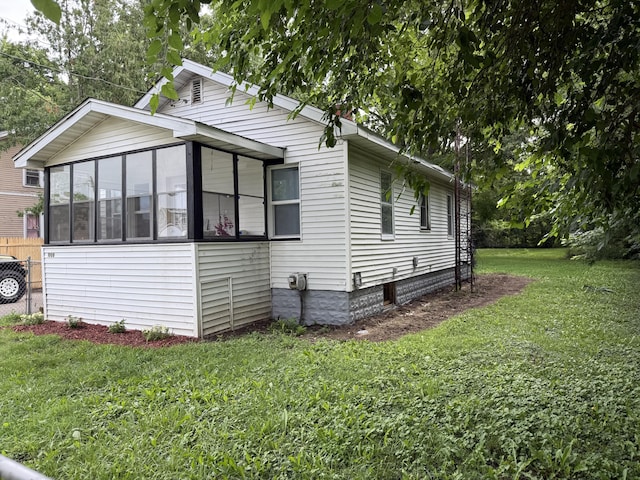 1008 Cooper Ave, Kalamazoo, MI 49048 - view of side of home featuring a yard and a sunroom