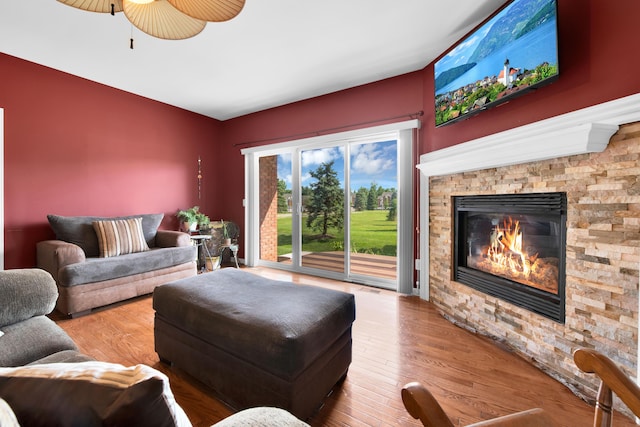 5196 Mesa Dr, Michigan, MI 48316 - living room with a stone fireplace, wood finished floors, and a ceiling fan