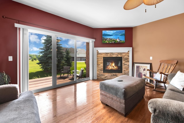 5196 Mesa Dr, Michigan, MI 48316 - living area featuring wood finished floors, a stone fireplace, and a ceiling fan