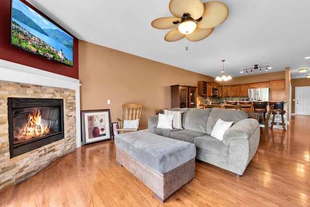 5196 Mesa Dr, Michigan, MI 48316 - living room featuring ceiling fan, light wood-type flooring, and a fireplace