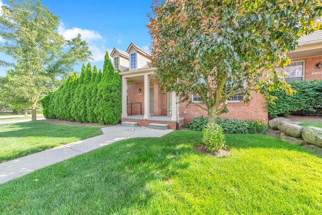 5196 Mesa Dr, Michigan, MI 48316 - obstructed view of property with brick siding, a front lawn, and covered porch