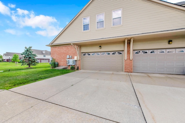 5196 Mesa Dr, Michigan, MI 48316 - view of side of home with brick siding, a yard, driveway, and an attached garage