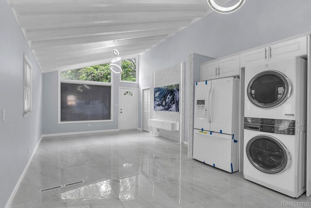 25288 Hopkins St, Dearborn Heights, MI 48125 - laundry area featuring stacked washing machine and dryer and light marble finish floors
